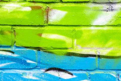 Graffiti painted on a brick wall texture. Stock Photos