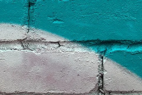 Graffiti painted on a brick wall texture. Stock Photos