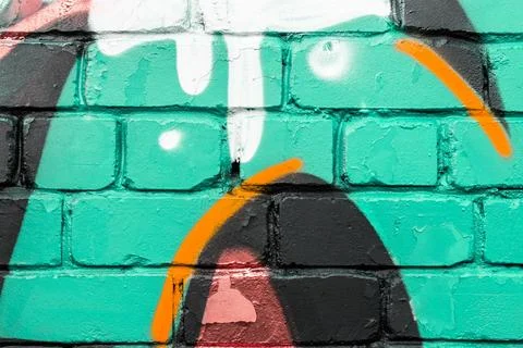 Graffiti painted on a brick wall texture. Stock Photos