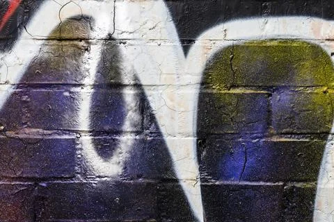 Graffiti painted on a brick wall texture. Stock Photos