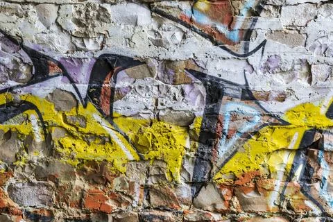 Graffiti painted on a brick wall texture. Stock Photos