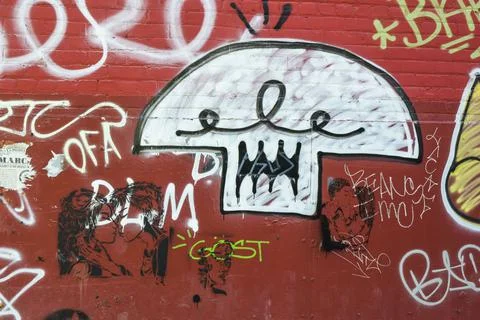 Graffiti on a red wall Stock Photos