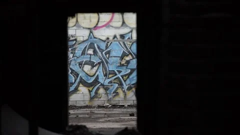 Graffiti seen through empty doorway in abandoned building Stock Footage 188956974