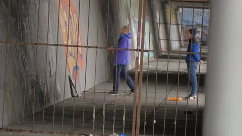 Graffiti. Teens paint on the wall. Stock Footage 83161369