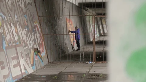 Graffiti. Teens paint on the wall. Stock Footage 83161446