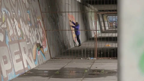 Graffiti. Teens paint on the wall. Stock Footage 83161463
