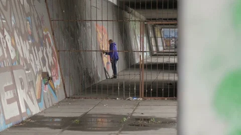 Graffiti. Teens paint on the wall. Stock Footage 83161513