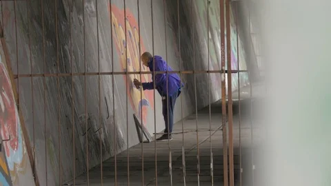 Graffiti. Teens paint on the wall. Stock Footage 83161602