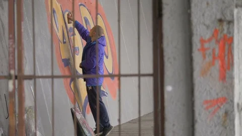 Graffiti. Teens paint on the wall. Stock Footage 83161671
