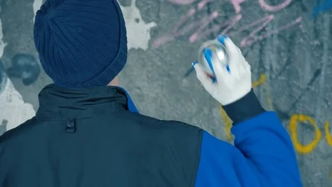 Graffiti. Teens paint on the wall. Stock Footage 83161836