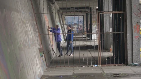 Graffiti. Teens paint on the wall. Stock Footage 83161943