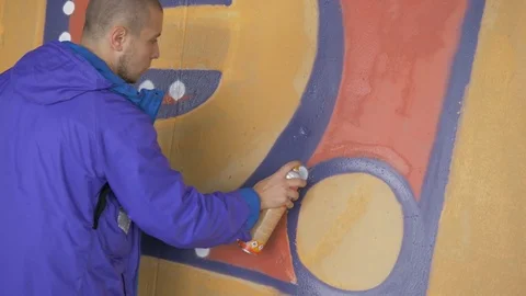 Graffiti. Teens paint on the wall. Stock Footage 83162190
