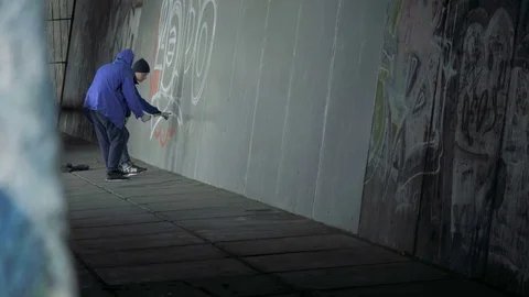 Graffiti. Teens paint on the wall. Stock Footage 83162790