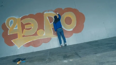 Graffiti. Teens paint on the wall. Stock Footage 83162990