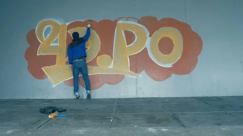 Graffiti. Teens paint on the wall. Stock Footage 83163230