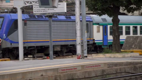 Graffiti train pulls through italian train station Stock Footage 141700975