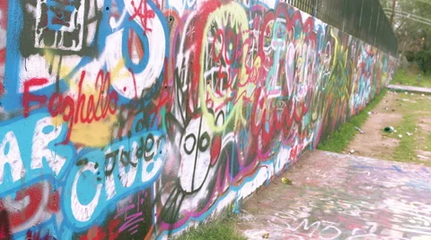 Graffiti Wall in Austin, Texas, MCU moving down wall, some trash in front Video stock 53348069