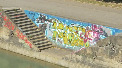 Graffiti on a wall on the Donaukanal riverbank in Vienna Stock Footage 59573613
