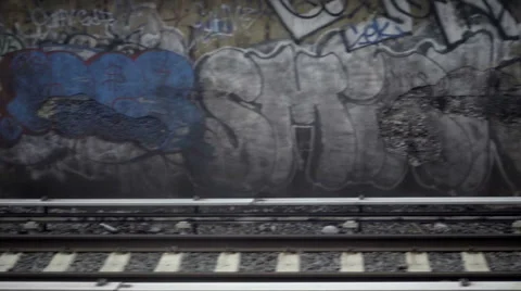 Graffiti on wall passing from moving subway train view above gritty tracks NYC 스톡 동영상 60766687