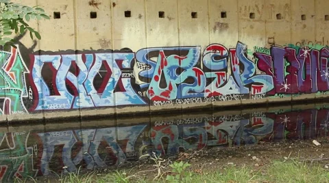 Graffiti wall. Reflection of graffiti in the water. Stock Footage 42681227