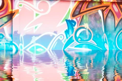 Graffiti wall texture reflection in  water, artistic urban picture Illustrazione stock