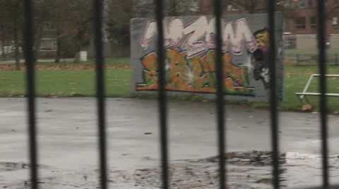 Graffiti on wall through fence Stock Footage 21240969