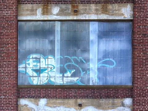 Graffiti on windows of abandoned building Stock Photos