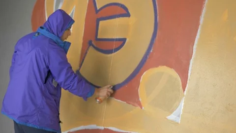 Graffiti. A young guy draws on the wall. Stock Footage 83160883