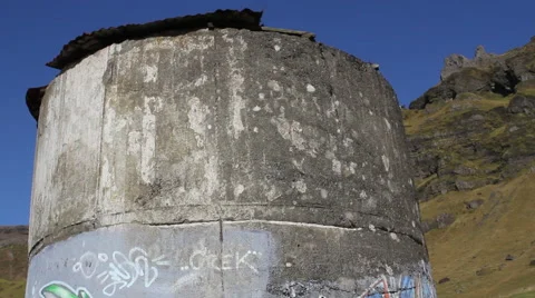 Graffitti art on cement structure in Iceland.  Mountains and grass are in Stock Footage 67835232