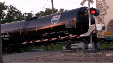 Graffittied Train passing the Cross Guard Stock Footage 44442759