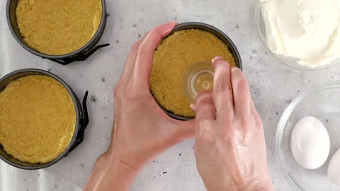 Graham cracker crust for the mini cheesecake recipe Stock Footage 267025204