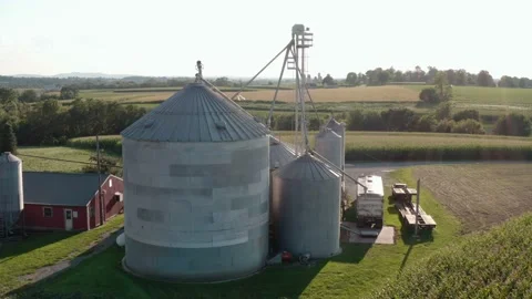 Grain bin elevator storage with truck in rural countryside farm. Aerial Stock Footage 163965084