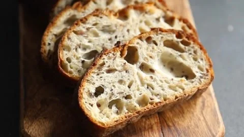 Grain bread oats sunflower, chia, flax seed, cut fresh tasty food dish Vidéo 303006409