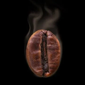 Grain of coffee close-up. On a wooden surface. One object. Stock Photos