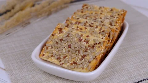 Grain cracker, rectangular bread or cookies with seeds and different seeds Stock Footage 165434256