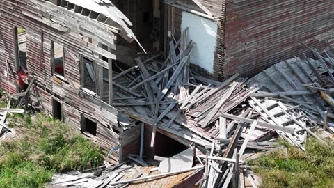 Grain elevagtor with a roof that is missing and a lot of wood debris Stock Footage 313810567