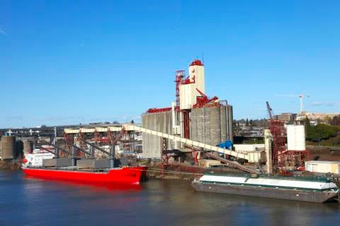 Grain elevator and cargo ship. Stock Photos