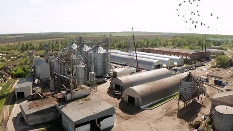 Grain elevator and storage facility in rural landscape Stock Photos