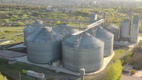 Grain elevator business with large storage bins of corn, grain Stock Footage 153527659