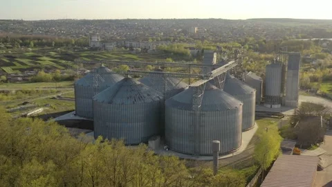 Grain elevator business with large storage bins of corn, grain Stock Footage 153527843