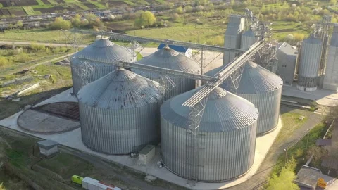 Grain elevator business with large storage bins of corn, grain Stock Footage 153528251