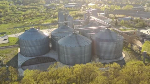 Grain elevator business with large storage bins of corn, grain Stock Footage 153528432