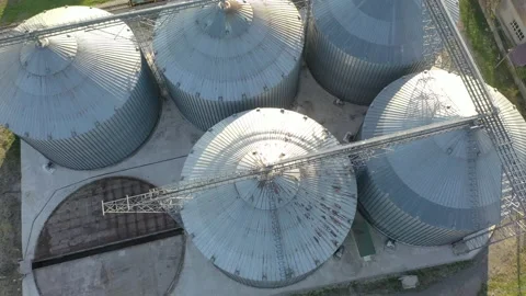 Grain elevator business with large storage bins of corn, grain Stock Footage 153529135