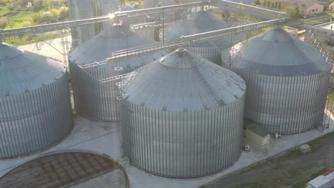 Grain elevator business with large storage bins of corn, grain Stock Footage 153529151