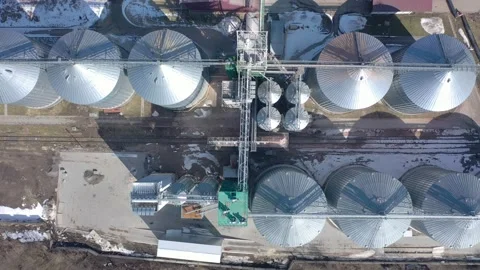 Grain elevator business with large storage bins of corn, grain Stock Footage 153542291