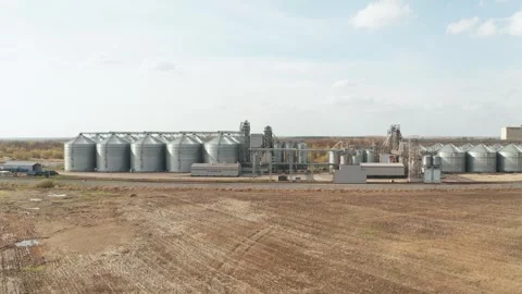 Grain elevator complex storing and processing harvested crops in rural landscape Stock Footage 309776247