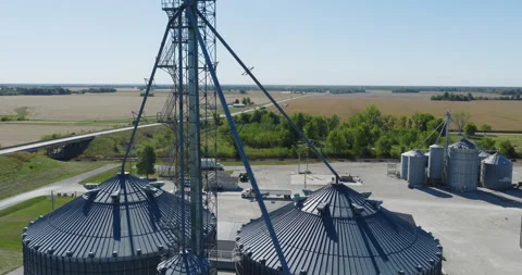 Grain Elevator With Expansive Farmland and Open Sky Stock Footage 323888818
