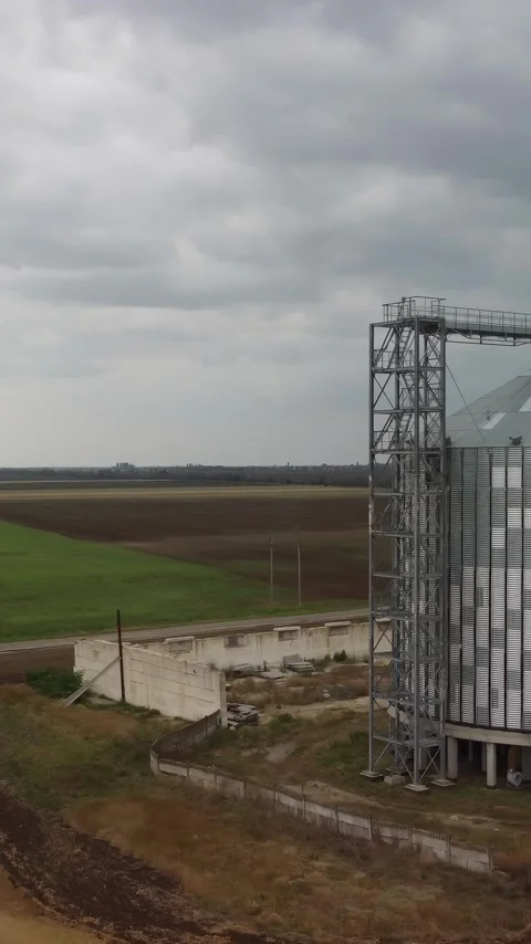 Grain elevator. Metal grain silo in agricultural zone. Agriculture storage for Stock Footage 256141596