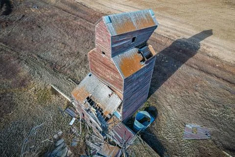 A grain elevator is in the middle of a field Stock Photos