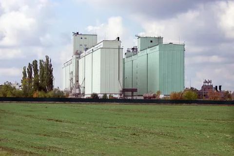 Grain elevator rises among the fields Stock Photos